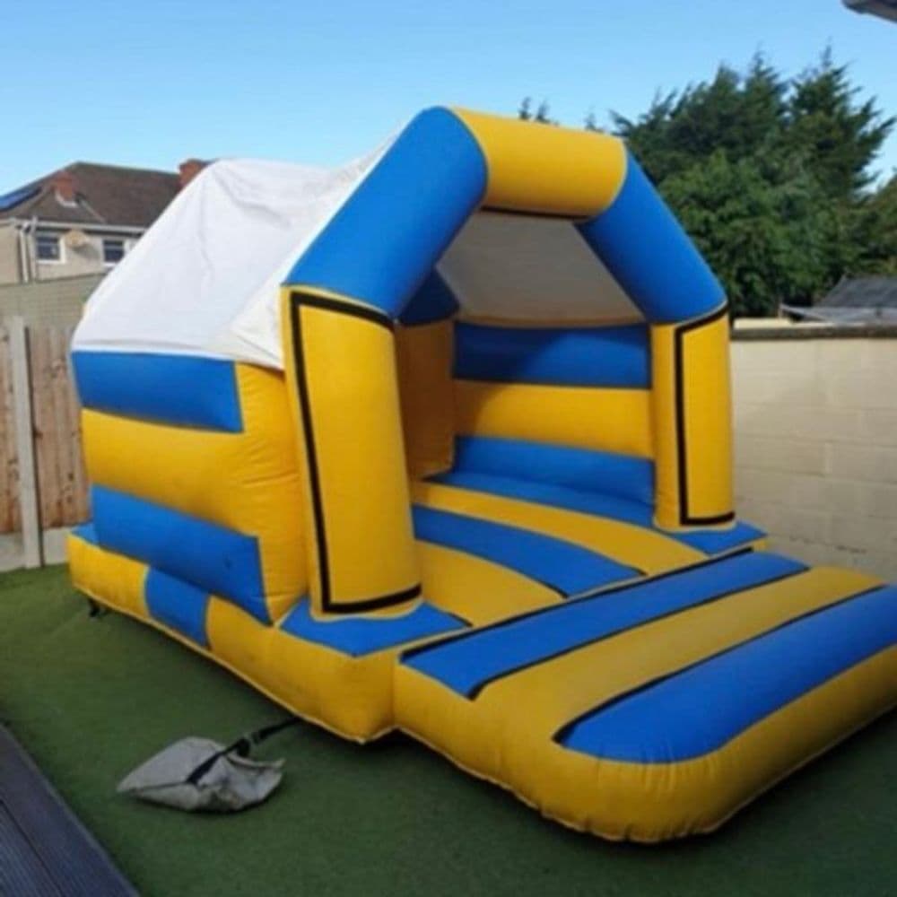 Midnight Blue bouncy castle with deep navy panels and a two-lane slide, the largest deck in the fleet.